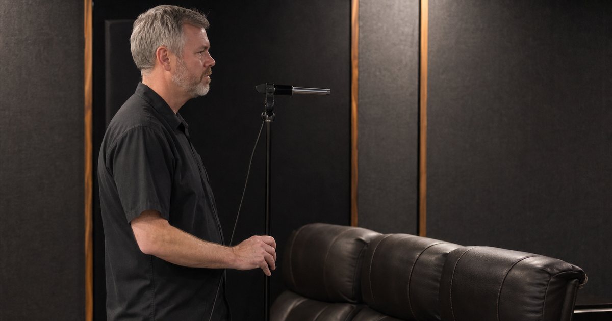 Why does seating choice affect the acoustics of a private home theater room?